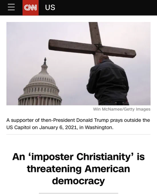 A picture of a person holding a cross with the dome of the US Capitol in the distance
