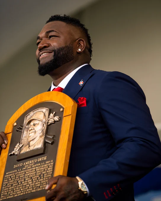 David Ortiz poses on-stage with Hall of Fame plaque. 