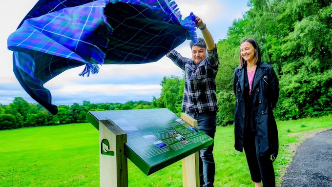 Mairi McAllan and Yustil Martinez unveil information board at the opening of the Commonwealth Foresters' Memorial