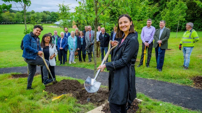 Mairi McAllan and Yutsil Martinez plant the last memorial tree in Pollok Country Park. 