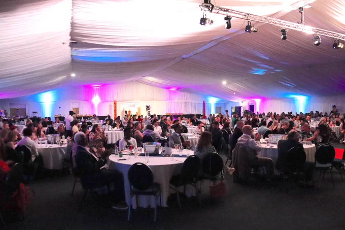 Guests sitting at the table in the hall.