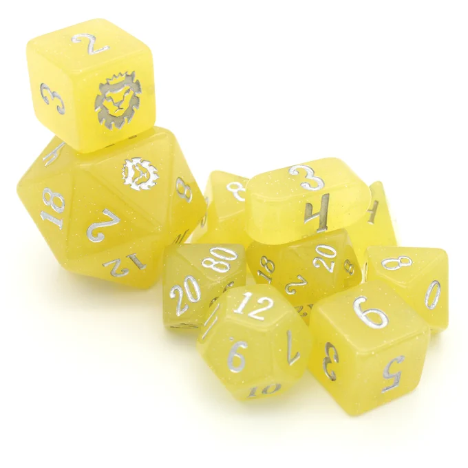 Limoncello is a ten piece polymer dice set in bright, semi-translucent yellow with embedded silver glitter and silver inked numbers. The ten piece set features a classic triangular prism D4, a patented Dice Envy pill shaped infinity D4, a standard D6, a slightly oversized D6 with the Dice Envy logo on the 6 face, a D8, a D10, a percentile D10, a D12, a standard D20 and an oversized Chonky Boi D20. 
