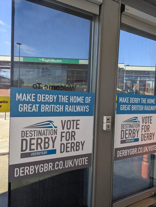 Vote for Derby GBR poster on glass door.