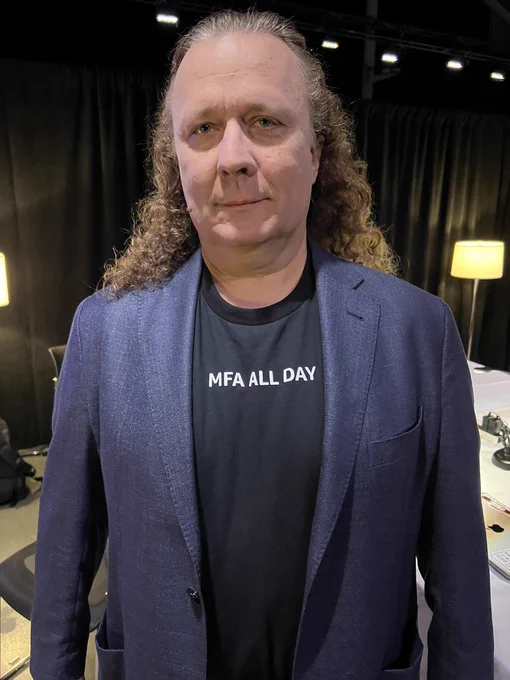 Kurt Kufeld from AWS wearing a shirt that says “MFA all day”