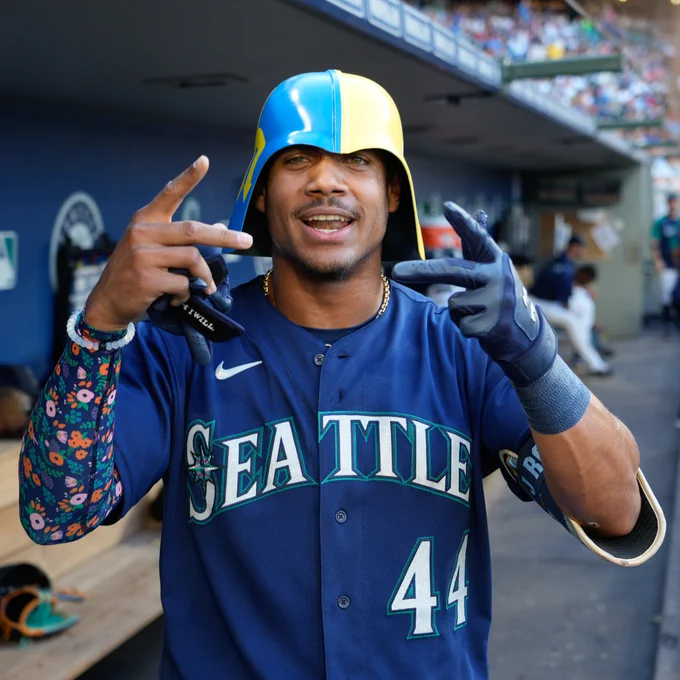 Julio Rodríguez celebrates in the dugout.