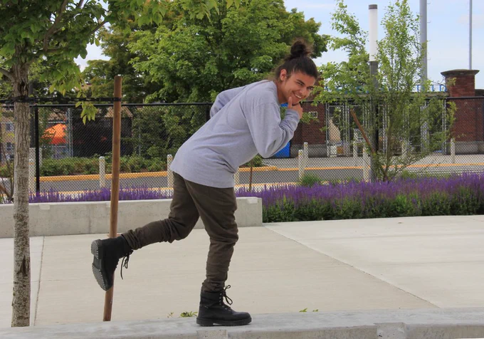 Student on concrete bench pretending to be running.
