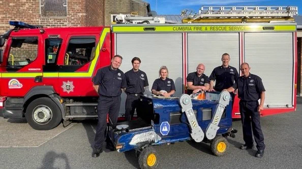 The team from CFRS stood in front of a fire engine with their 'Soap Box' vehicle