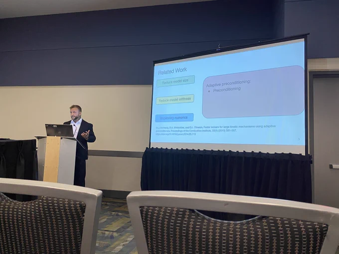 Man giving a presentation in front of a projector screen