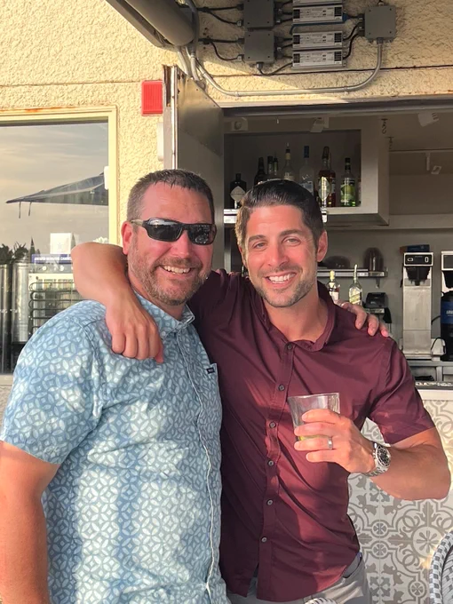 A PCI employee posing and smiling with a customer.