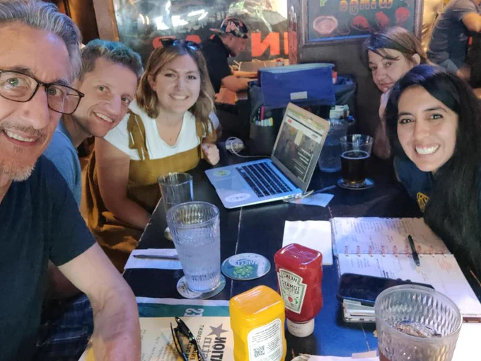 Picture of Education Austin members seated at a table and smiling during a School Board Watch committee planning meeting