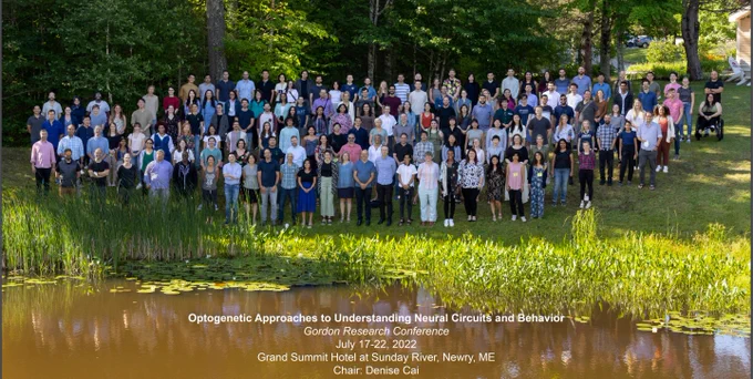 Group photo from Opto GRC 2022 - approximately 200 attendees standing outside. 