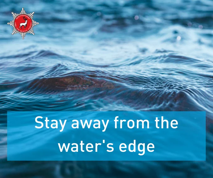 Lapping water with text: Stay away from the water's edge