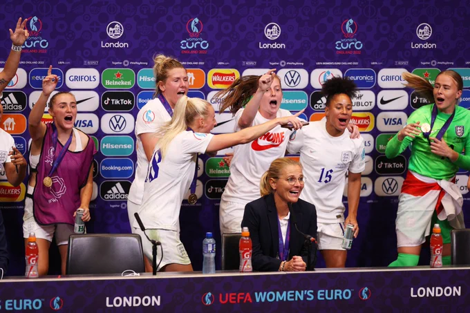 England's players celebrate in the press conference room