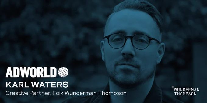 Headshot of Karl Waters with a blue overlay/filter.

Text reads Karl Waters, Creative Partner, FOLK Wunderman Thompson & the Wunderman Thompson logo shows in the bottom right of the image. 

Above the text the, ADWORLD logo in white is placed.
