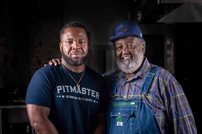 Hall of Fame Pitmaster Ed Mitchell and his son Ryan Mitchell, the heir to the "BBQ Throne." Pictured in their new restaurant, the Preserve, scheduled to open in 2023 in Raleigh, NC.