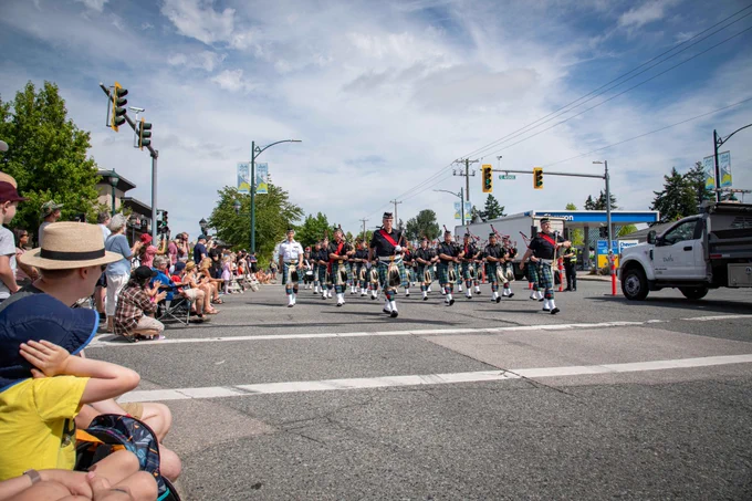 Delta Police Pipe Band and Chief Neil Dubord walking in the Tsawwassen Sun Fest parad.