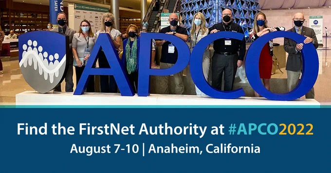 A group of FirstNet Authority personnel standing behind a very large APCO sign at the entrance of the conference;
"Find the FirstNet Authority at #APCO2022; August 7-10; Anaheim, California