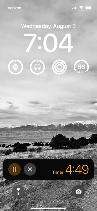 iPhone lock screen. Picture of Colorado mountains. 7:04. Timer on screen with 4 minutes, 49 seconds. 