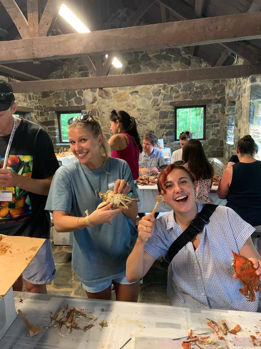 Two people smiling with crabs one has a mallet