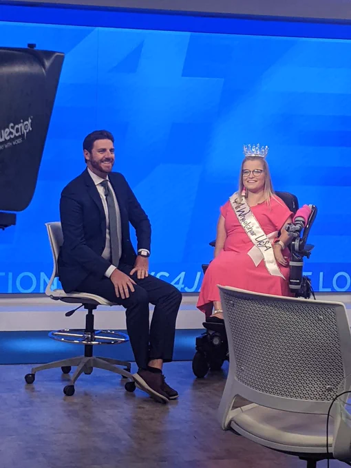 Sara sitting next to Vic Micolucci getting ready for her interview.