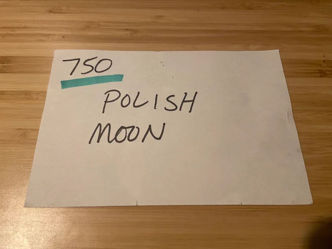 A paper index card used for tracking work tasks that reads “Polish Moon”
