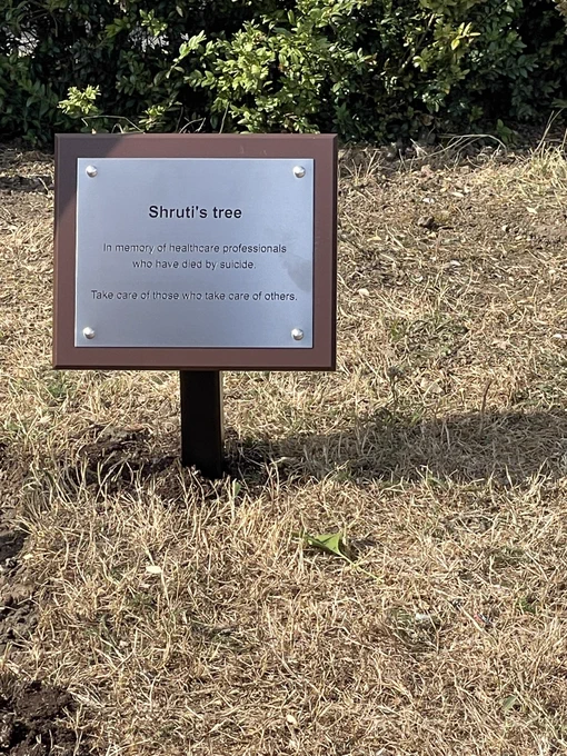 A plaque reading “Shruti’s tree. In memory of healthcare professionals who have died by suicide. Take care of those who take care of others.”