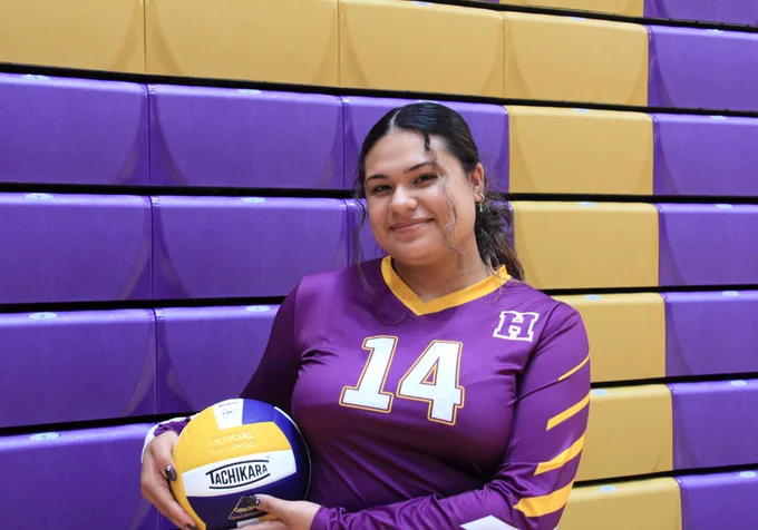 Student posing with volleyball