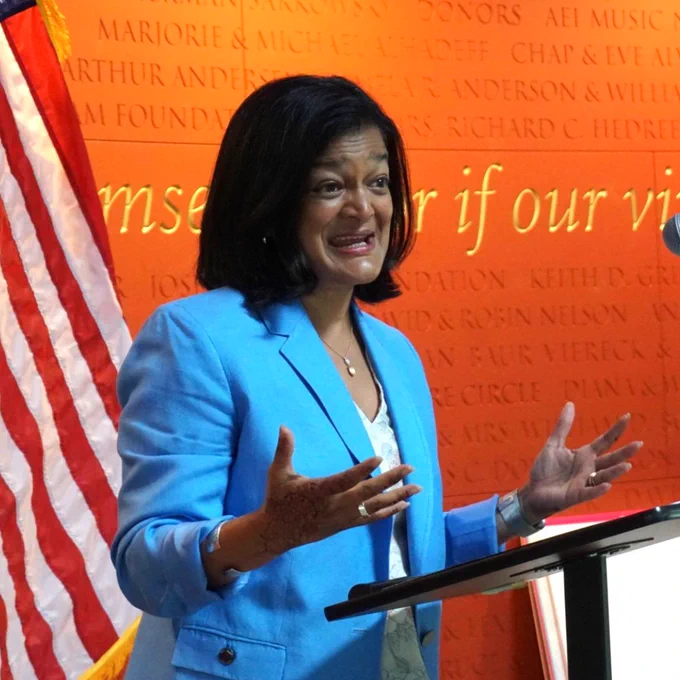 Congresswoman Pramila Jayapal speaks at a podium in Seattle.