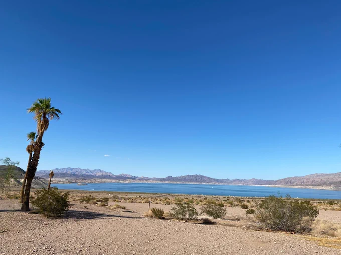 The shoreline of Swim Beach with Lake Mead and mountains in the distance. 