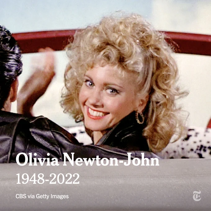 Olivia Newton-John, dressed as her character, Sandy, from "Grease," is pictured waving from a red convertible. Text reads: Olivia Newton-John. 1948-2022. Photo by CBS via Getty Images.