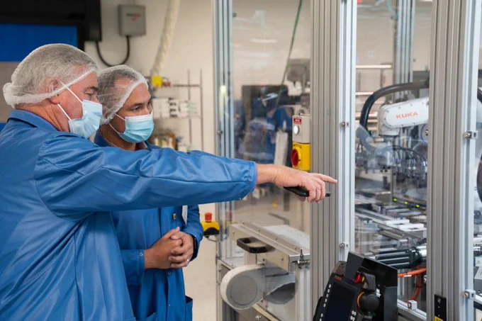 Rep. Trone looks at COVID-19 test kits during a tour of Ellume