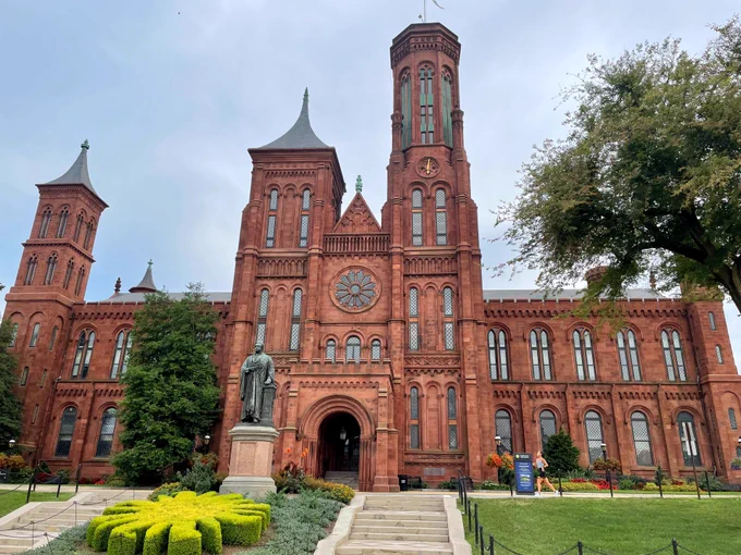 A large red brick building with ornate towers.