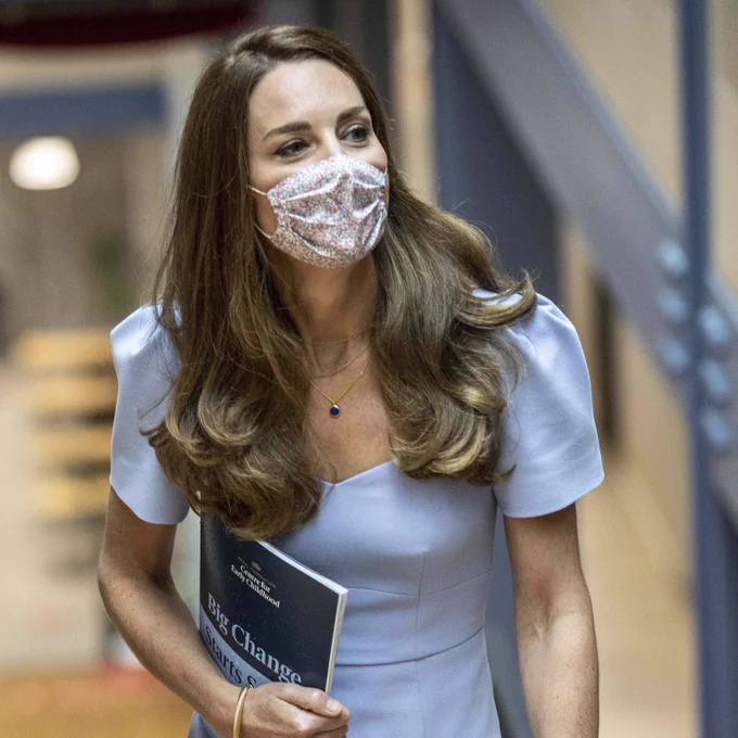 The Duchess of Cambridge climbs the stairs holding a copy of the Big Change Starts Small report