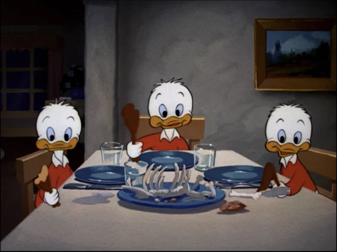 Ducks Huey, Dewey and Louie stare at the camera after devouring a roast turkey. The bones sit in the foreground.