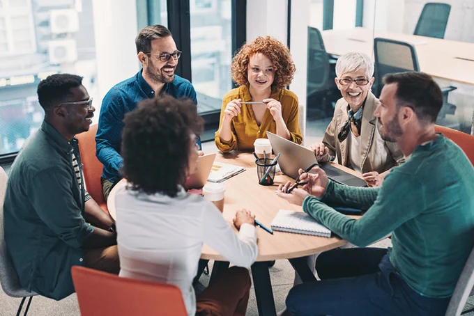Group of 6 professionals having a discussion