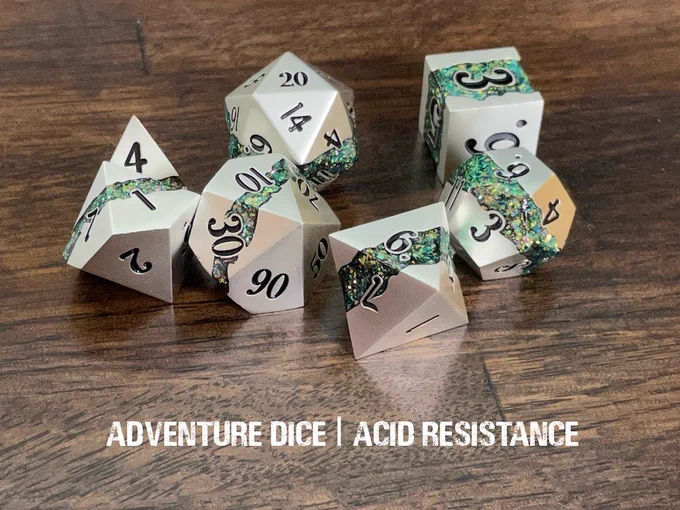 Acid Resistance metal dice set are a matte silver metal with veins of green sparkles, and black numbering.