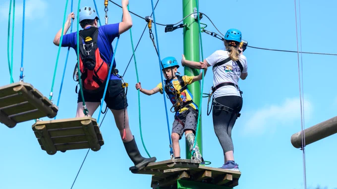 Children take part in a high ropes course.