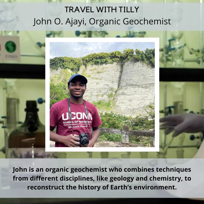 Foreground: John posing for a picture in front of a mountain, holding a DSLR camera in his hands. The text at the top is "Travel with Tilly: John O. Ajayi, Organic Geochemist." The caption at the bottom is: "John is an organic geochemist who combines techniques from different disciplines, like geology and chemistry, to reconstruct the history of Earth’s environment."