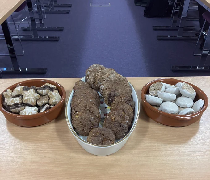 A classroom table with three bowls of cookies, one homemade, two professionally made