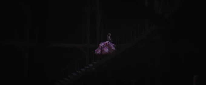 Ariana Grande as Glinda in a pink gown running up stairs