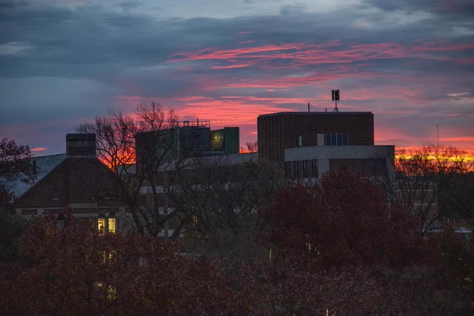 A pink sunrise over Kedzie Hall, Computer Center and the Hannah Administation Building.