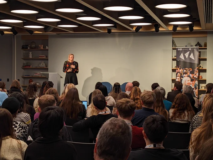 Jo Burnham on stage watched by a crowd of delegates sat in rows at Digital Marketing Day.