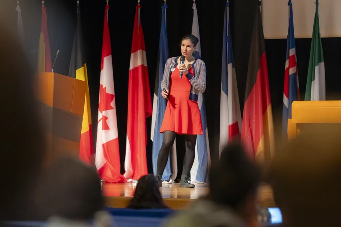 Marine Cusa standing on stage in front of the audience delivering a keynote speech at ICES Annual Science Conference 2023.