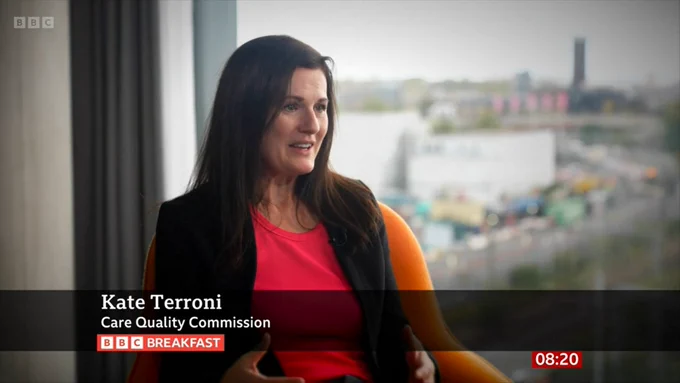 A screengrab from a package on BBC Breakfast discussing safety ratings for maternity services in England. The image shows Kate Terroni, Interim Deputy Chief Executive at the Care Quality Commission, seated in front of a window and responding to a question being asked by the interviewer. At the bottom of the screen a graphic reads 'Kate Terroni, Care Quality Commission'. Beneath this is the BBC Breakfast logo and in the bottom right hand corner a clock displays the time as 08:20.