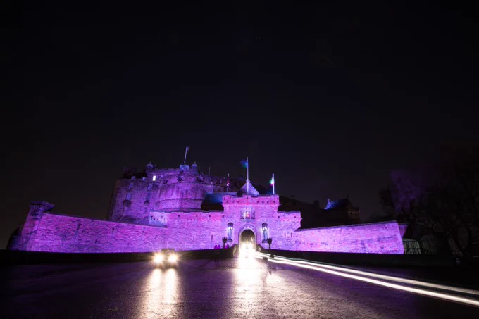 Castle entrance floodlit in purple.