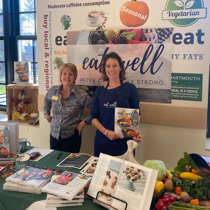 Here’s a photo of Renee Plodzik holding her new cookbook, standing beside Dartmouth Dining’s nutritionist, Beth Rosenberger.