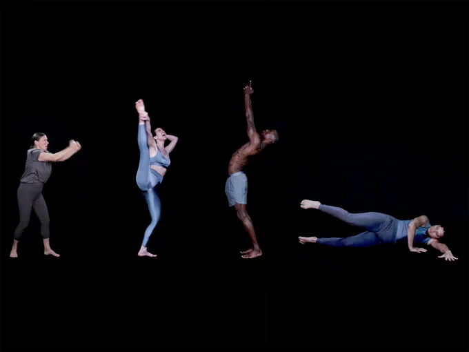 A group of four dancers on a black background.