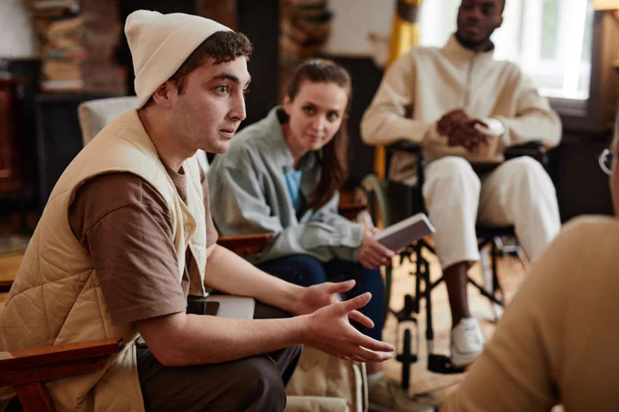 Teenage student talking in a group of teenagers