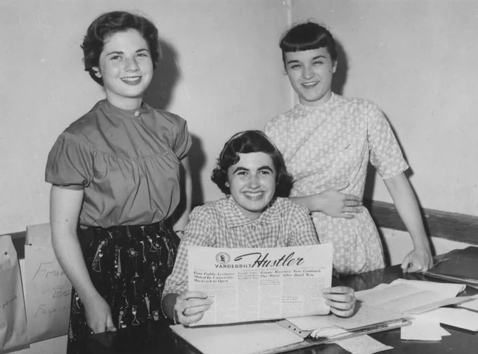 Three members of Hustler student staff, Subscriptions Staff, holding an issue of The Hustler. Black and White photograph