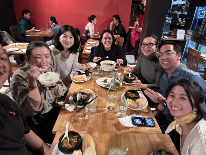 Photo of people posing for a selfie at the table